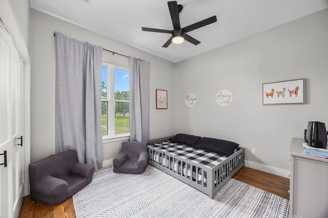 a spacious bedroom with a bed a couch and a window