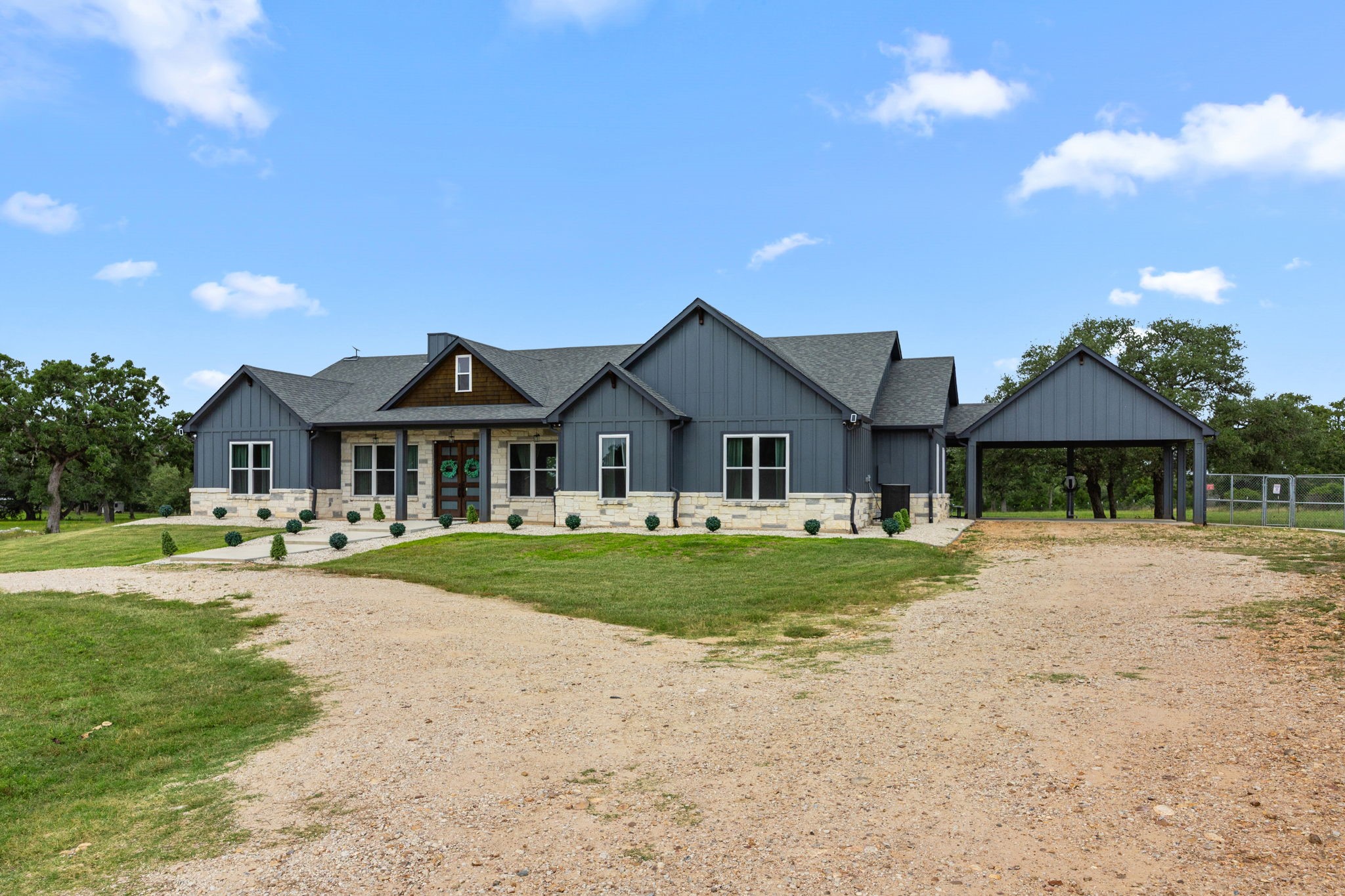 1507 Smith Rau Road Columbus, TX 78934 - Photo 3 of 50 a front view of a house with a yard and porch