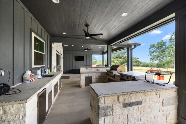 a view of a kitchen with kitchen island a large window in it