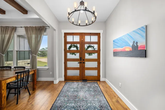 a view of a bedroom with furniture window and wooden floor