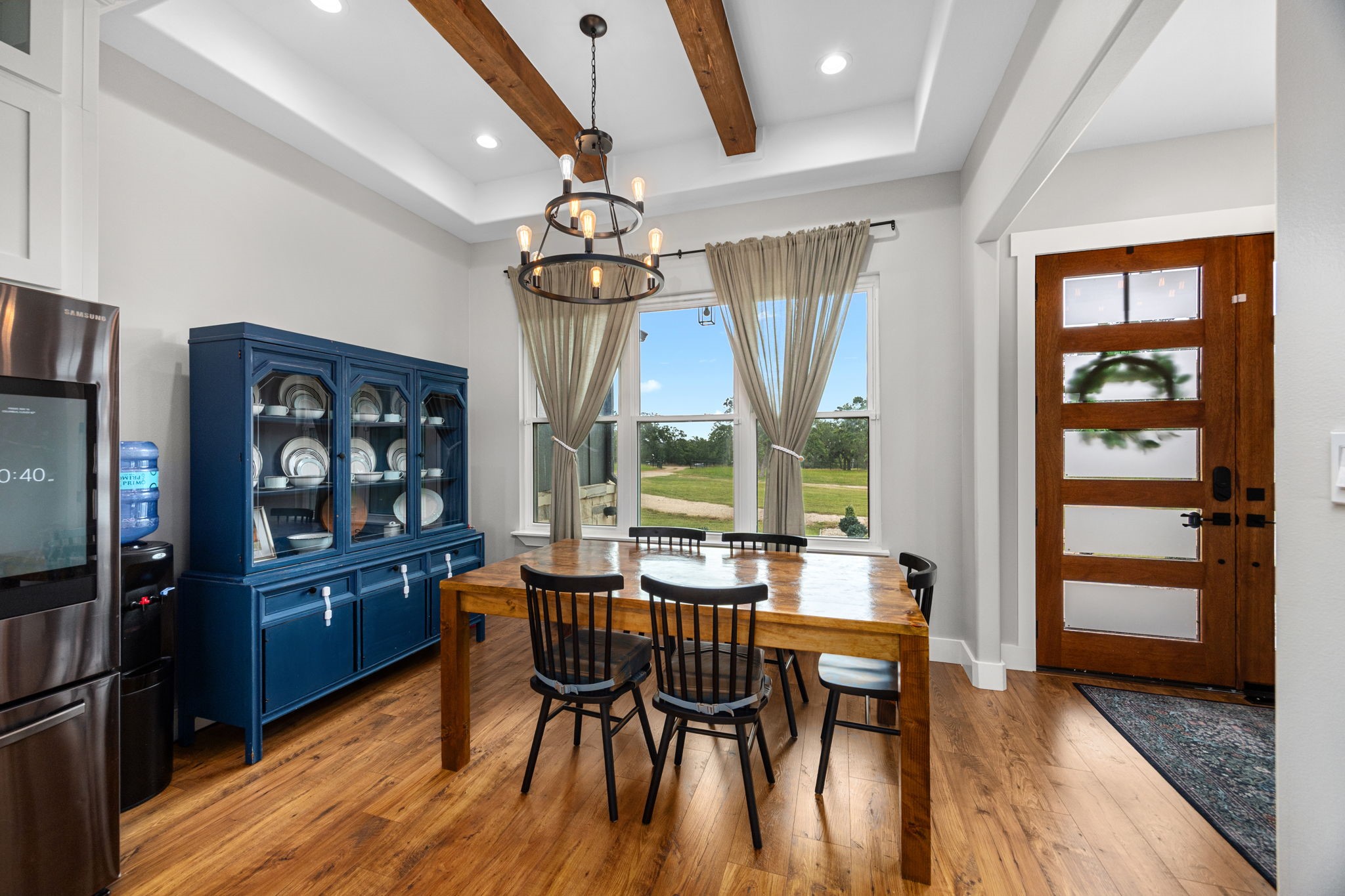 1507 Smith Rau Road Columbus, TX 78934 - Photo 6 of 50 a dining room with wooden floor a chandelier a wooden table and chairs