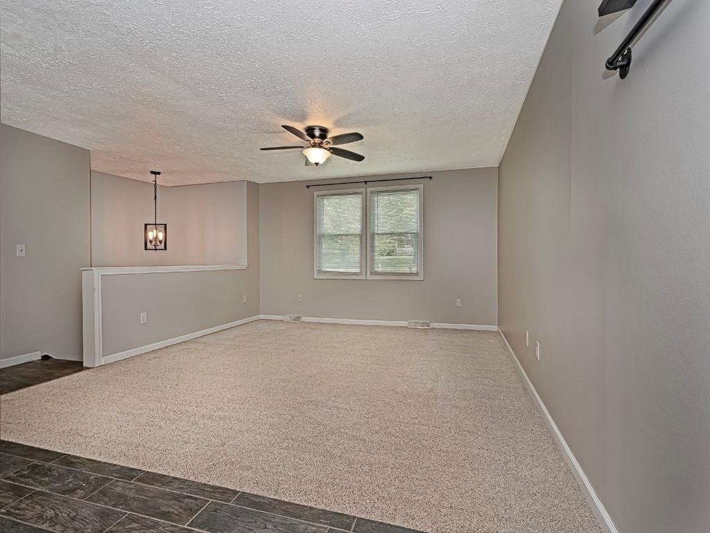 516 South Eberhart Road Butler, PA 16001 - Photo 8 of 31 an empty room with windows and ceiling fan