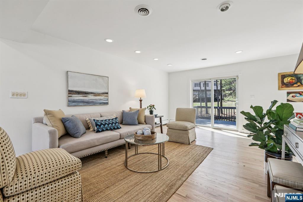11 Carlough Road Upper Saddle River, NJ 07458 - Photo 19 of 41 a living room with furniture potted plant and wooden floor
