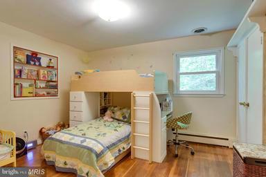 6609 Robin Road Springfield, VA 22150 - Photo 13 of 28 a bedroom with a bed and wooden floor