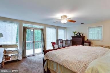 6609 Robin Road Springfield, VA 22150 - Photo 14 of 28 a bed room with a bed and a chandelier