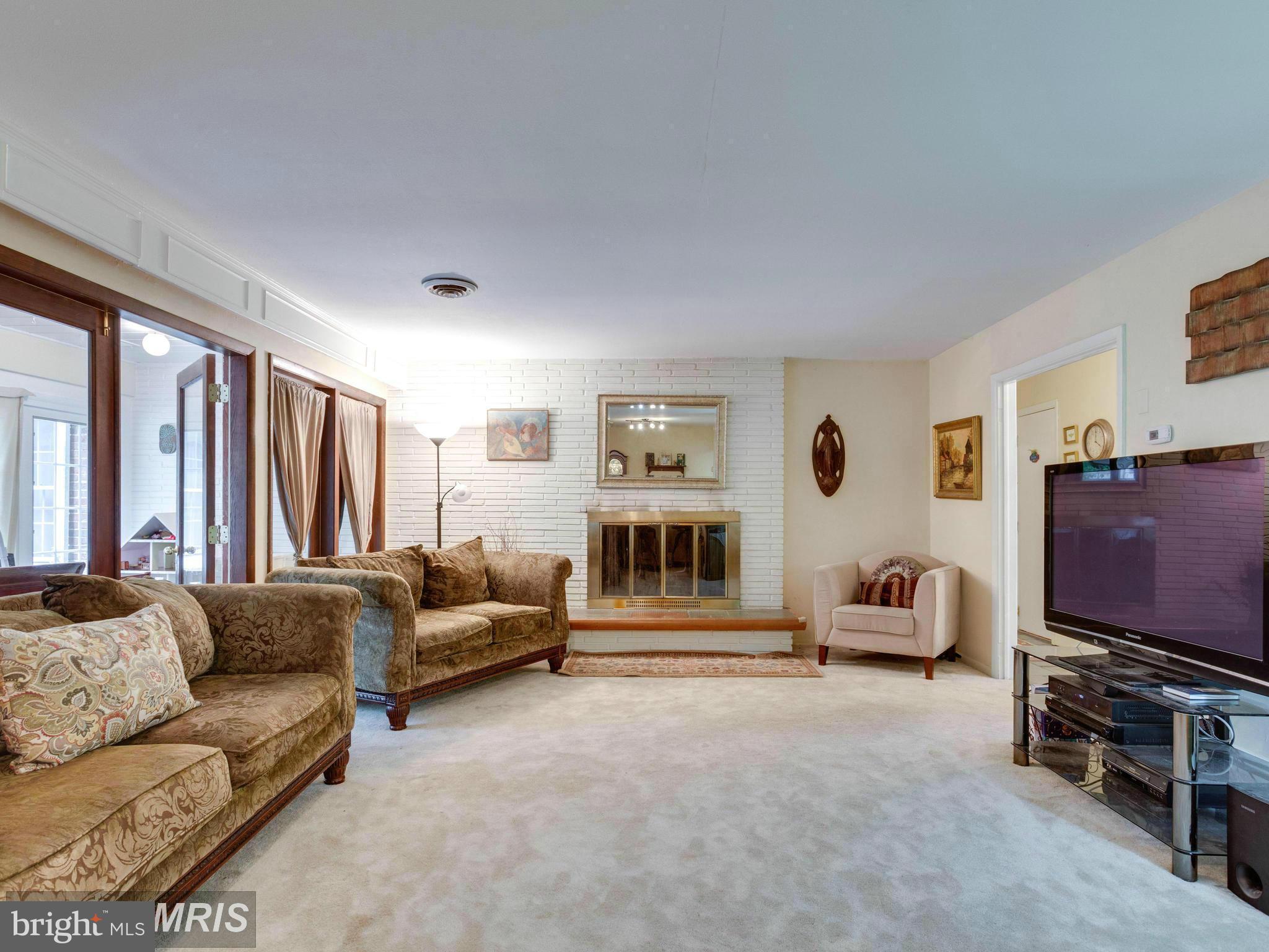 6609 Robin Road Springfield, VA 22150 - Photo 3 of 28 a living room with furniture and a flat screen tv