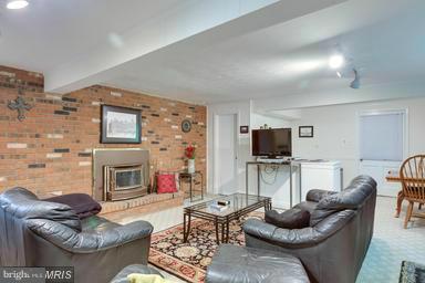 6609 Robin Road Springfield, VA 22150 - Photo 21 of 28 a living room with fireplace furniture and a flat screen tv