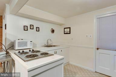 6609 Robin Road Springfield, VA 22150 - Photo 23 of 28 a white stove top oven sitting inside of a kitchen