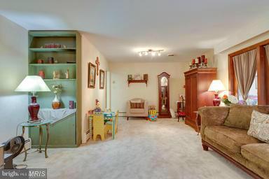 6609 Robin Road Springfield, VA 22150 - Photo 5 of 28 a living room with furniture and a flat screen tv