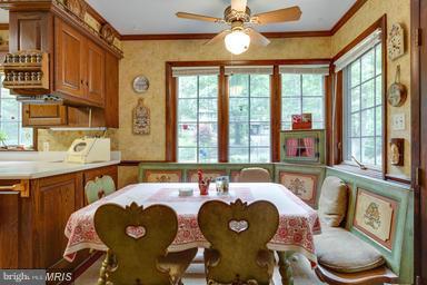 6609 Robin Road Springfield, VA 22150 - Photo 7 of 28 a view of a dining room with furniture and a chandelier
