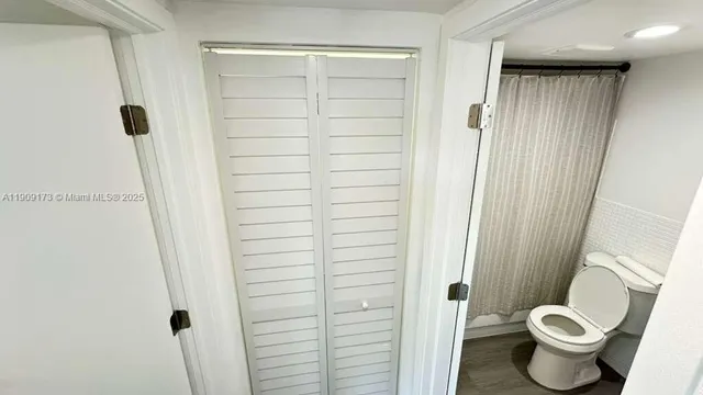 a bathroom with a shower and a toilet