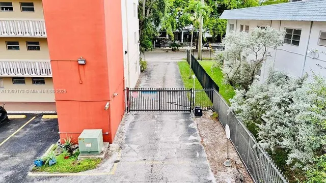 a view of a path along with potted plants