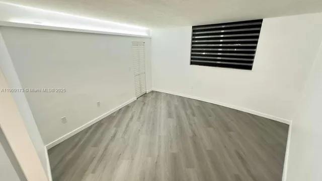 an empty room with wooden floor