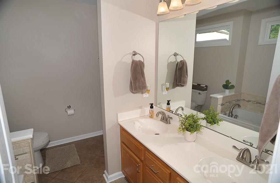 2396 Sides Road Rockwell, NC 28138 - Photo 14 of 20 a bathroom with a granite countertop sink and a mirror