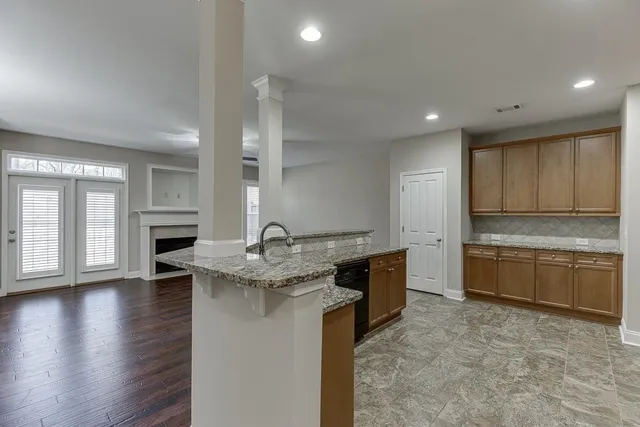 a kitchen with stainless steel appliances granite countertop a sink stove and cabinets