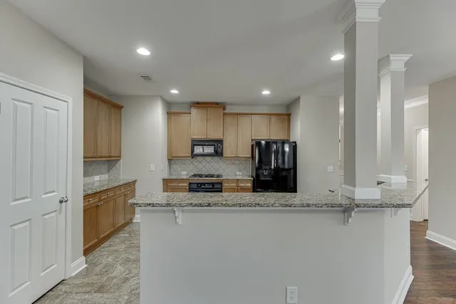 a large kitchen with stainless steel appliances granite countertop a granite counter tops and white cabinets