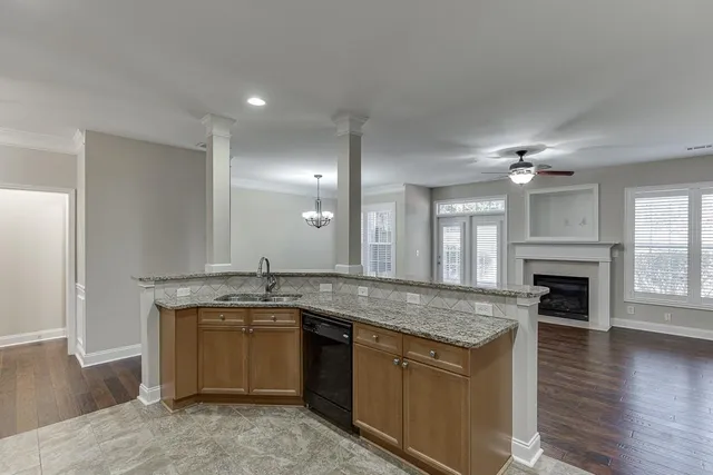 a kitchen with a granite countertop sink a stove and oven