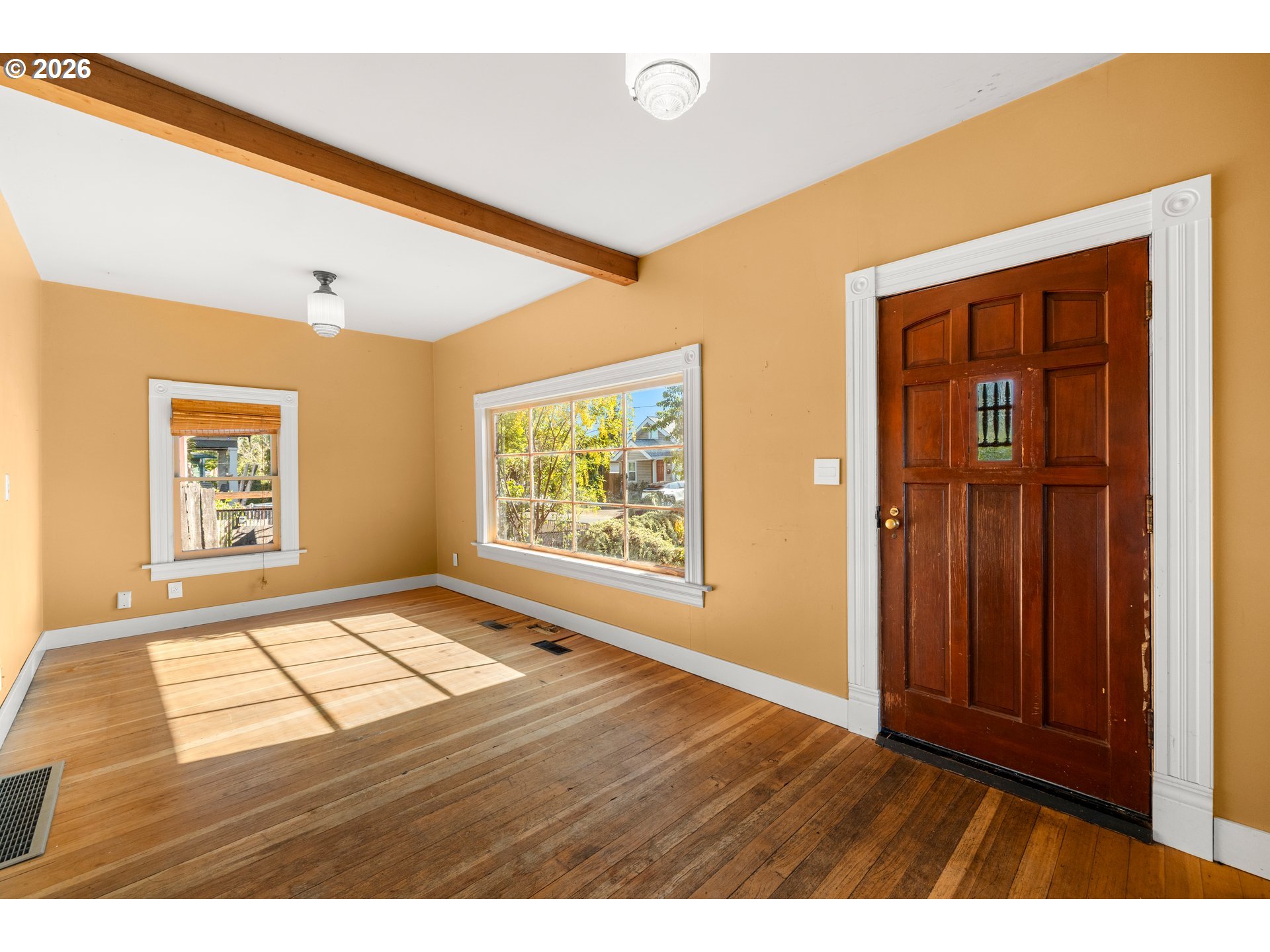 3909 Southeast 69th Avenue Portland, OR 97206 - Photo 4 of 15 a view of an empty room with window and wooden floor