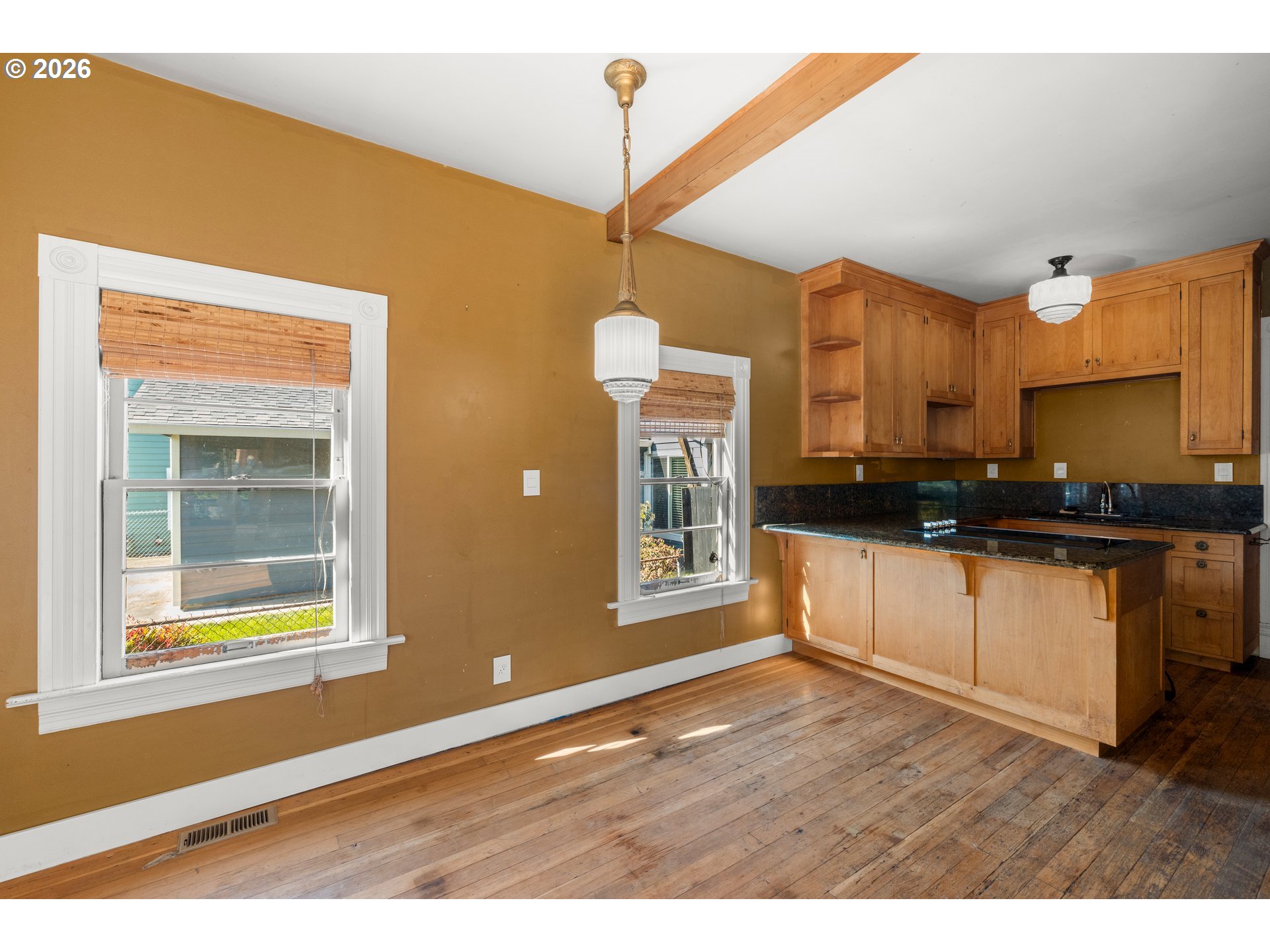 3909 Southeast 69th Avenue Portland, OR 97206 - Photo 6 of 15 a kitchen with stainless steel appliances granite countertop a stove a sink and a refrigerator with wooden floor