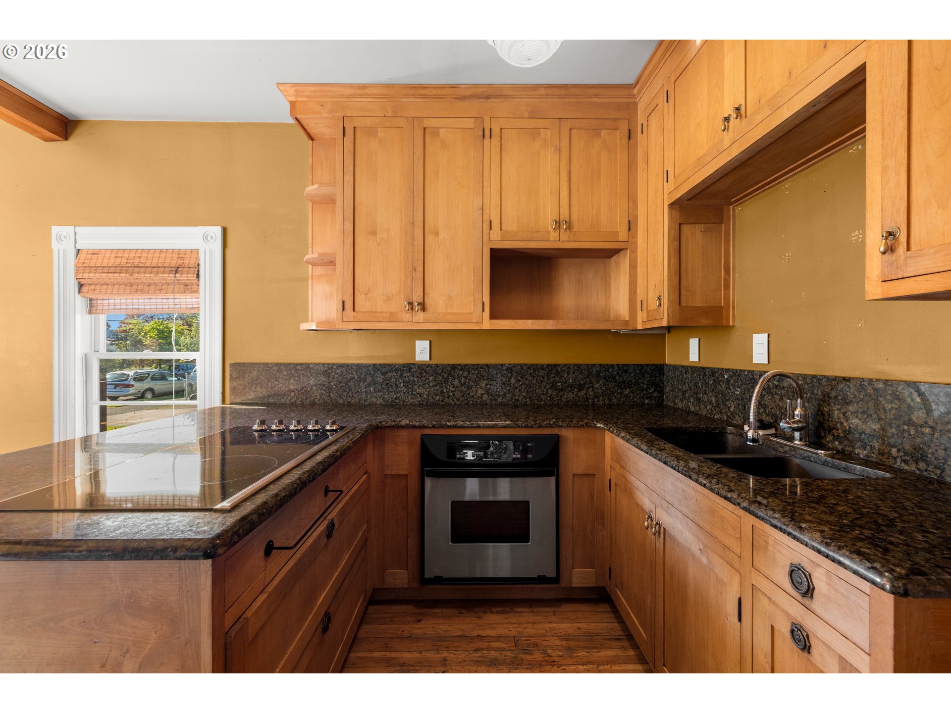 3909 Southeast 69th Avenue Portland, OR 97206 - Photo 7 of 15 a kitchen with granite countertop a sink stove and cabinets