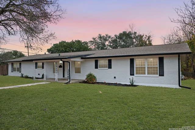 a front view of house with yard and trees