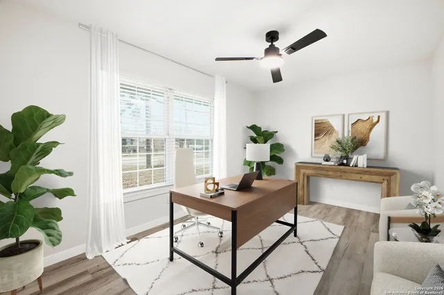 a living room with furniture and a potted plant