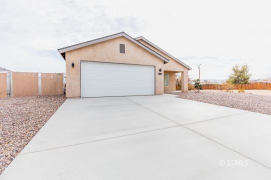 1204 South McCall Street Ridgecrest, CA 93555 - Photo 4 of 27 a view of a house with a yard and garage
