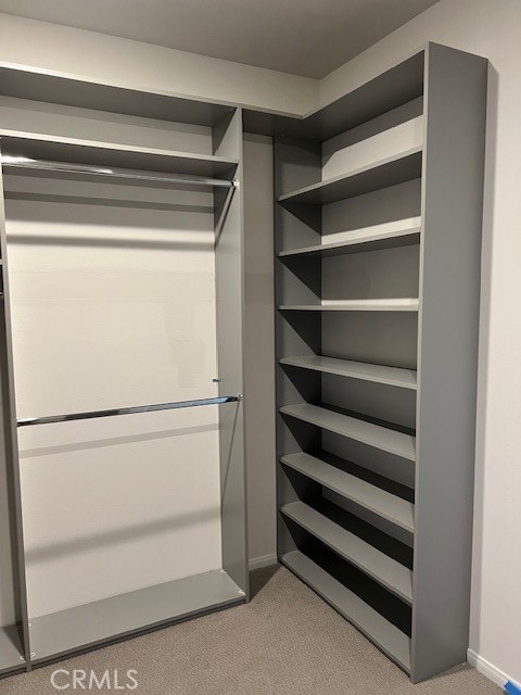 29901 Bridlegate Way Menifee, CA 92584 - Photo 21 of 43 a view of walk in closet with empty racks
