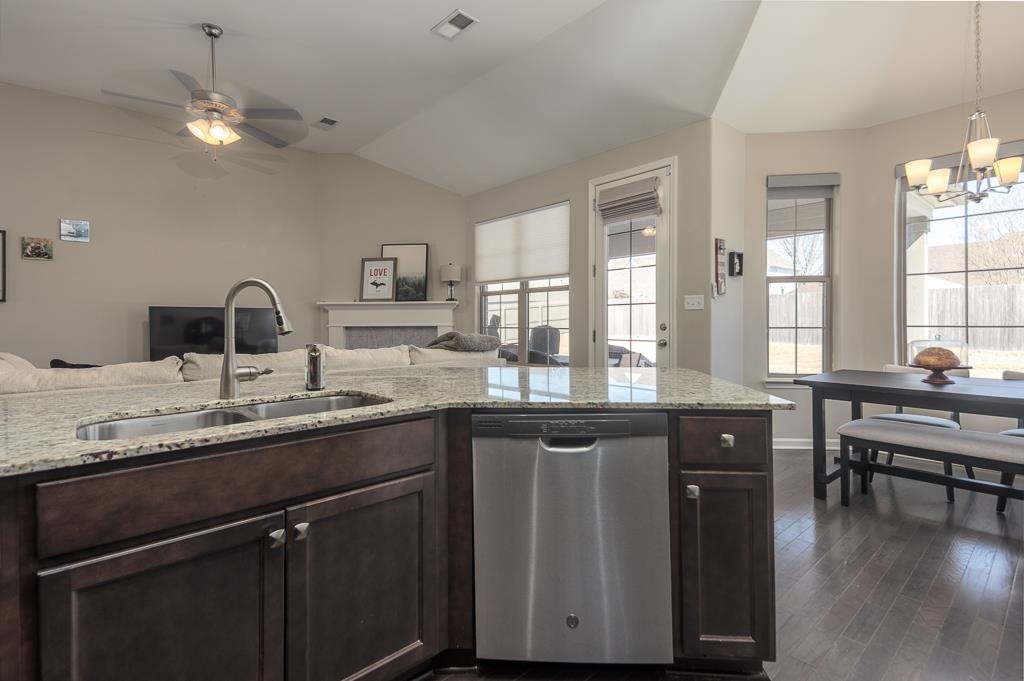 95 Chesnut Rdg Drive Oakland, TN 38060 - Photo 33 of 33 Kitchen featuring dark wood finish cabinets, dishwasher, light stone counters, open floor plan, and lofted ceiling