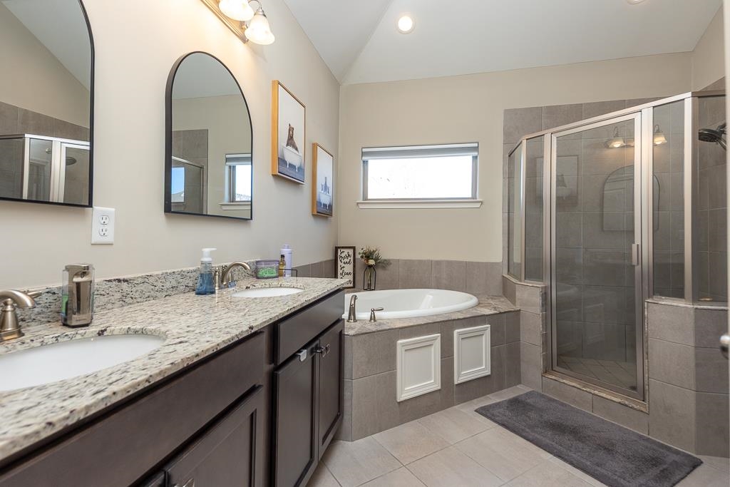 95 Chesnut Rdg Drive Oakland, TN 38060 - Photo 13 of 33 Full bath with a bath, a shower stall, double vanity, light tile patterned floors, and lofted ceiling