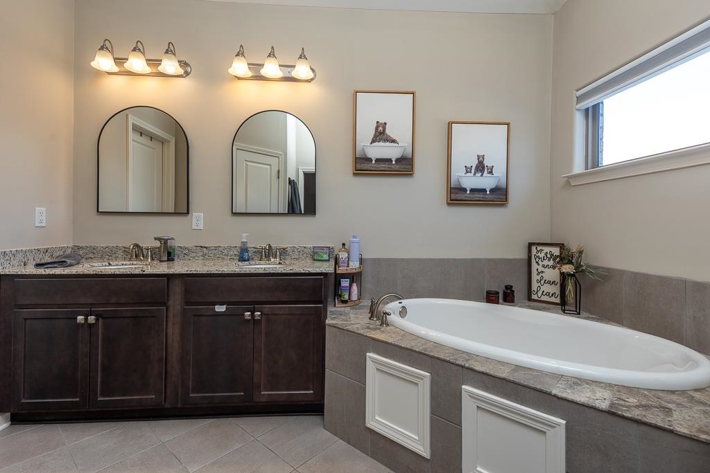 95 Chesnut Rdg Drive Oakland, TN 38060 - Photo 15 of 33 Full bathroom featuring a garden tub, double vanity, and light tile patterned floors