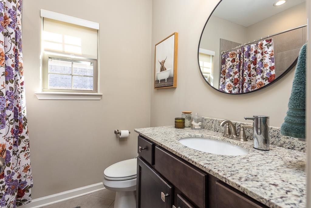 95 Chesnut Rdg Drive Oakland, TN 38060 - Photo 14 of 33 Bathroom with curtained shower, vanity, and light tile patterned floors