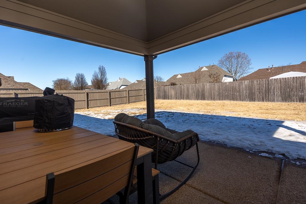 95 Chesnut Rdg Drive Oakland, TN 38060 - Photo 23 of 33 Fenced backyard with area for grilling, a patio, and outdoor dining space