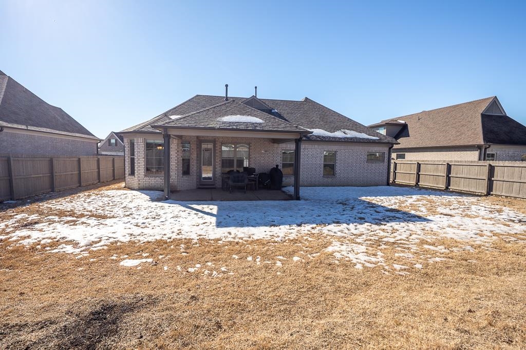95 Chesnut Rdg Drive Oakland, TN 38060 - Photo 25 of 33 Snow covered rear of property with brick siding, a patio, and a fenced backyard