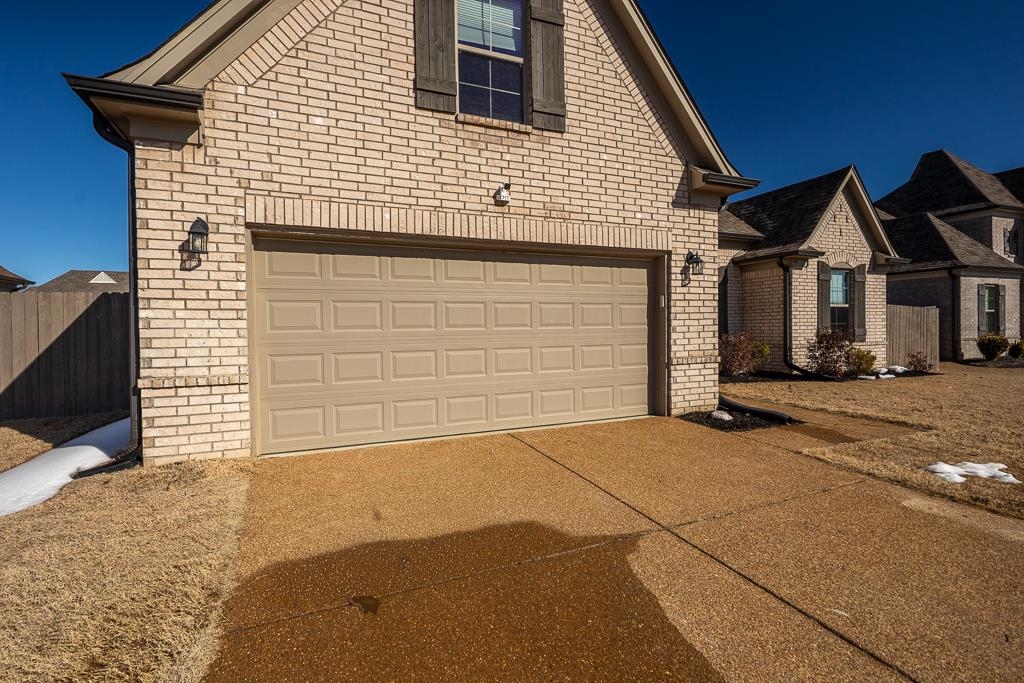 95 Chesnut Rdg Drive Oakland, TN 38060 - Photo 29 of 33 View of front of property featuring brick siding, concrete driveway, and an attached garage