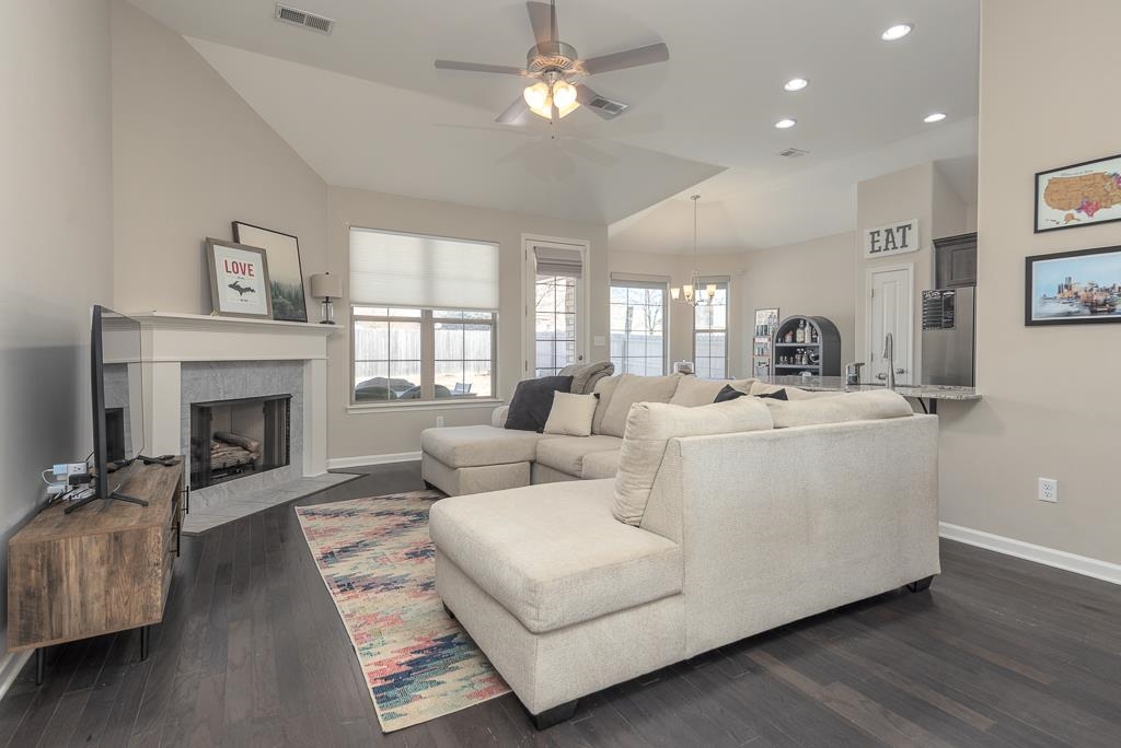 95 Chesnut Rdg Drive Oakland, TN 38060 - Photo 4 of 33 Living area featuring ceiling fan, recessed lighting, dark wood-style flooring, a fireplace with flush hearth, and lofted ceiling