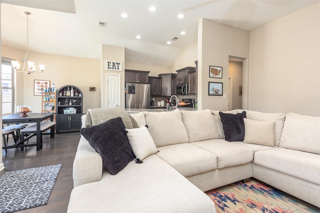 95 Chesnut Rdg Drive Oakland, TN 38060 - Photo 5 of 33 Living area featuring dark wood finished floors, a chandelier, and lofted ceiling