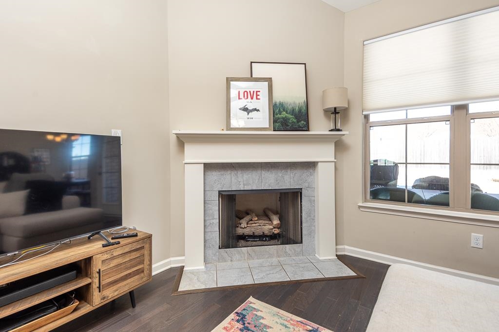 95 Chesnut Rdg Drive Oakland, TN 38060 - Photo 6 of 33 Living area with wood finished floors and a tiled fireplace