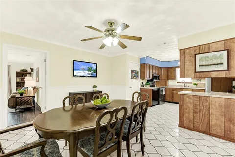 a view of a dining room with furniture and a chandelier