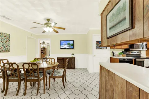 a view of a dining room with furniture and chandelier