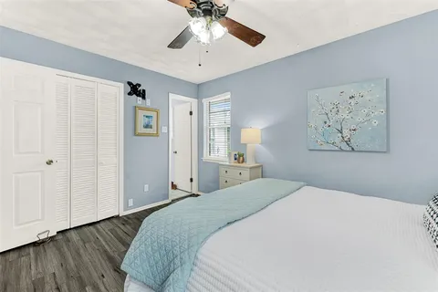 a bedroom with a large bed and a chandelier