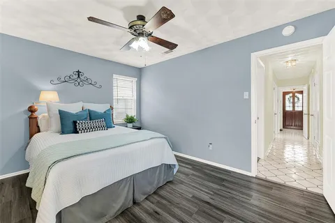 a bedroom with bed and wooden floor