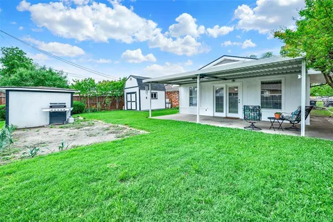a view of a house with a yard and sitting area