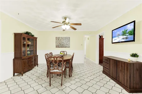 a dining room with furniture and wooden floor