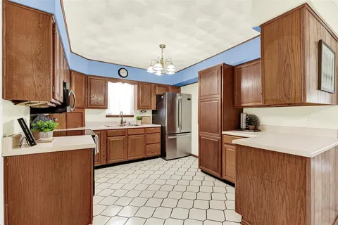 a kitchen with a sink appliances and cabinets