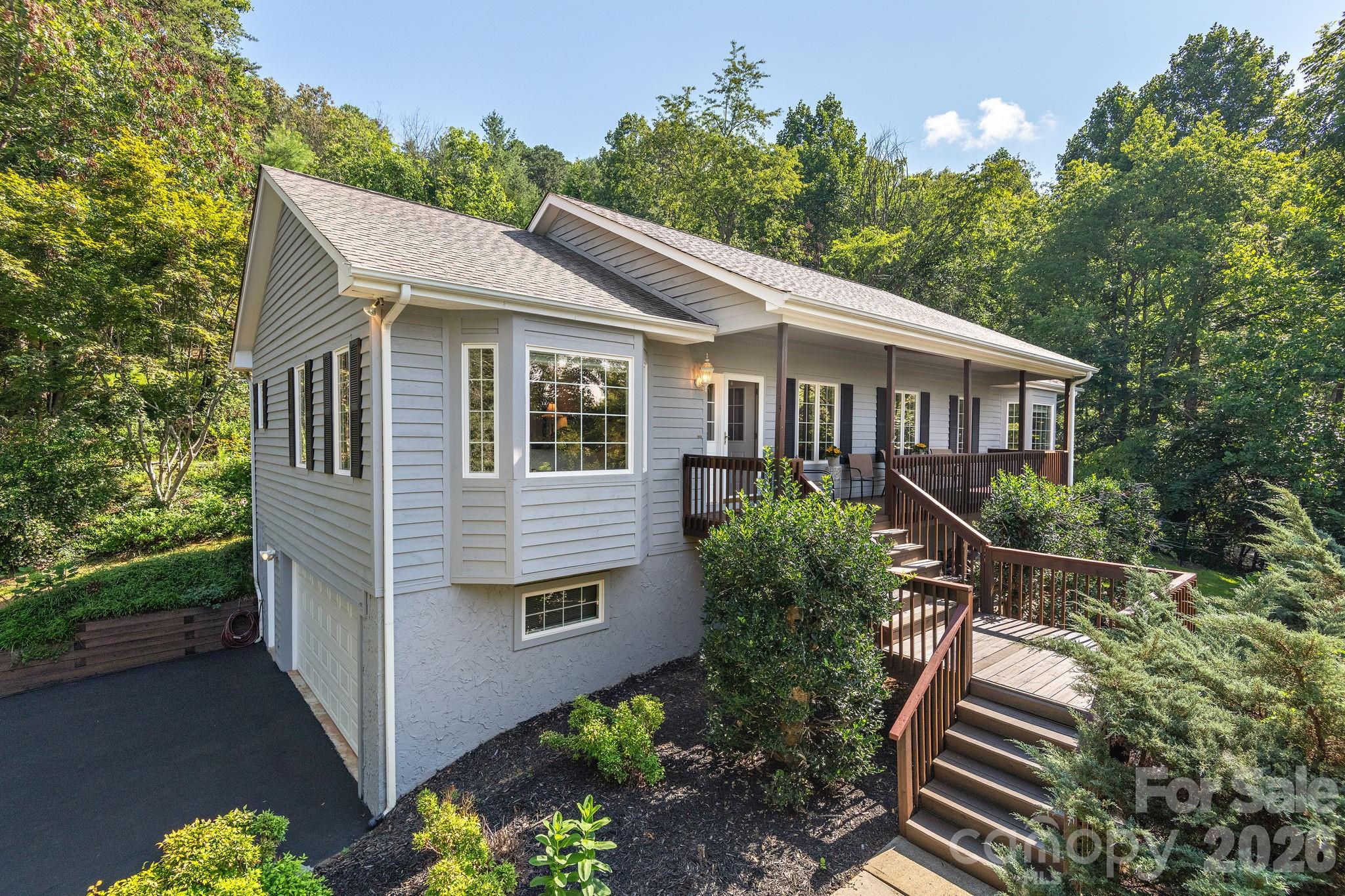 212 Blue Ridge Vista Asheville, NC 28805 - Photo 1 of 42 a house with trees in the background
