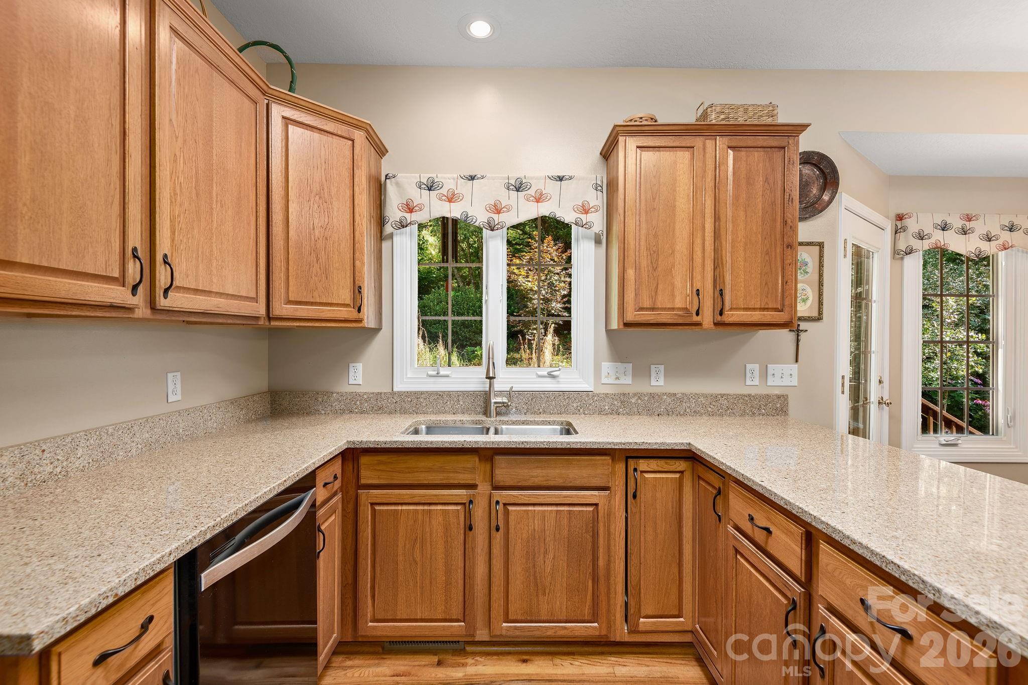 212 Blue Ridge Vista Asheville, NC 28805 - Photo 11 of 42 a kitchen with granite countertop a sink and cabinets