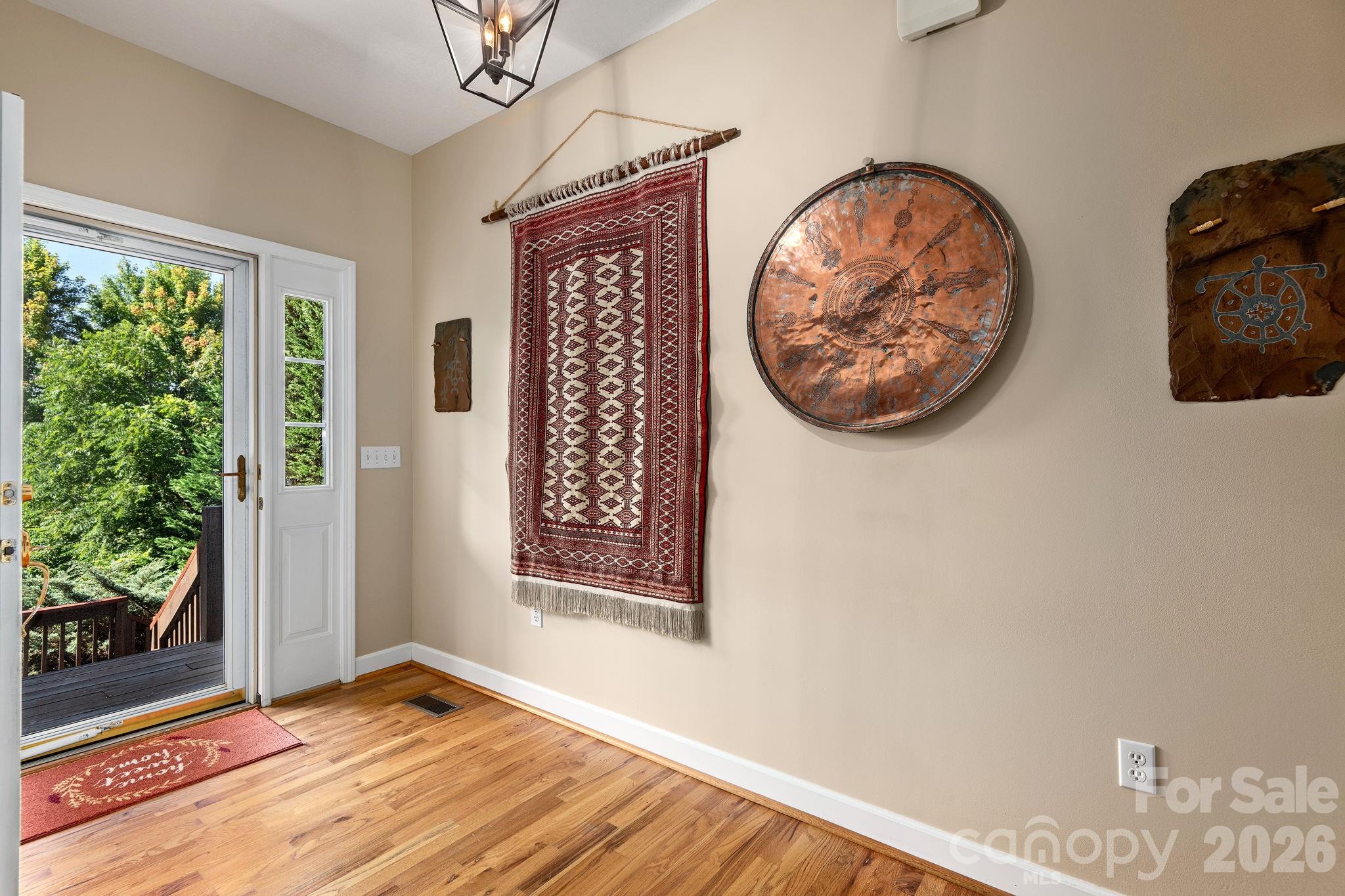 212 Blue Ridge Vista Asheville, NC 28805 - Photo 6 of 42 an entryway with wooden floor and windows