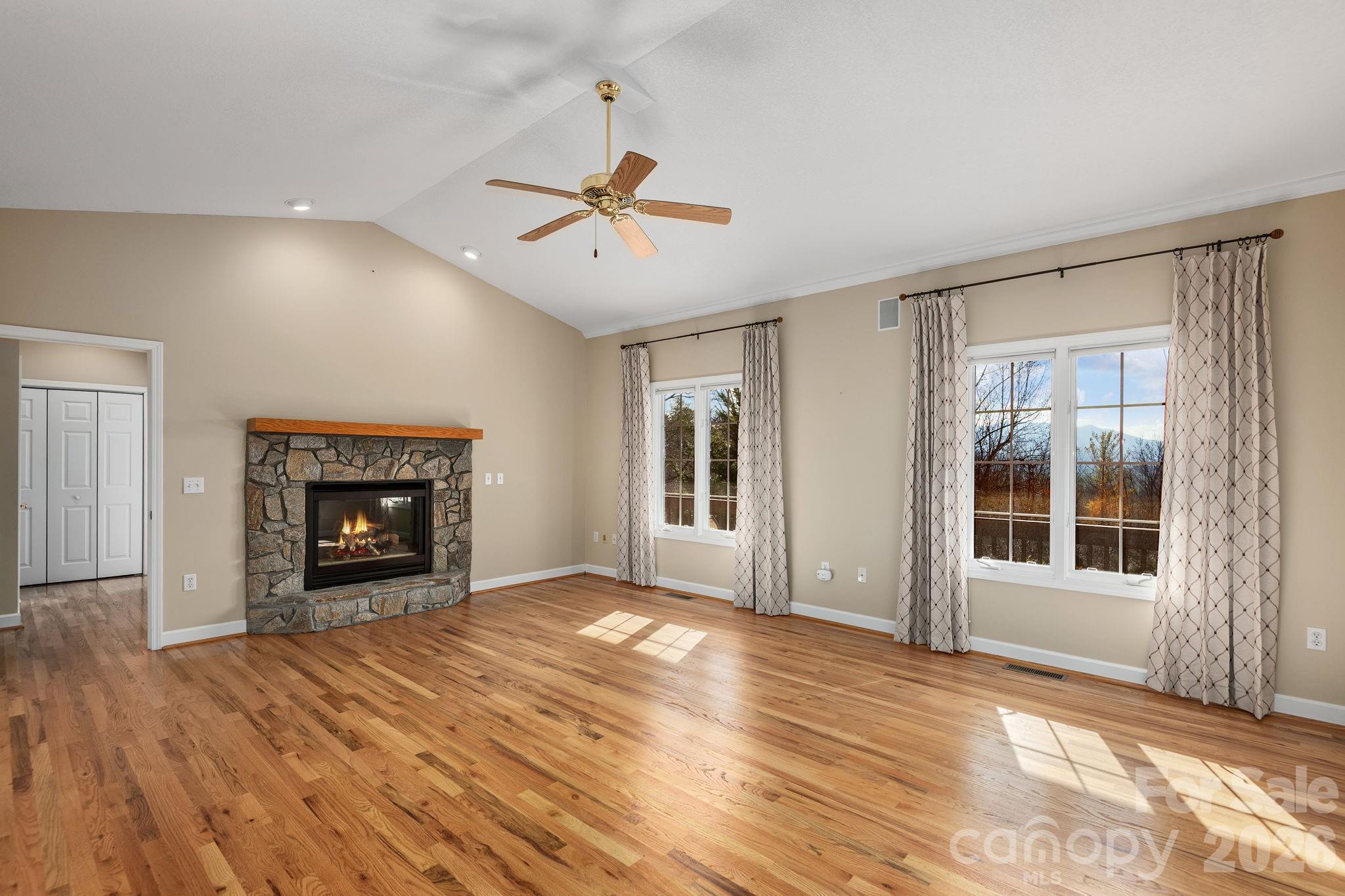 212 Blue Ridge Vista Asheville, NC 28805 - Photo 8 of 42 a view of an empty room with a window and fireplace