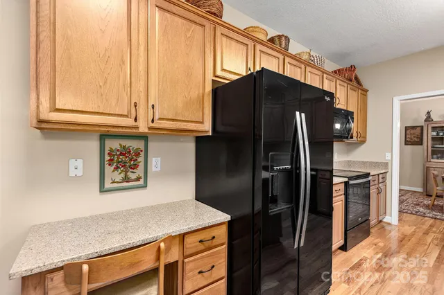 a bathroom with a granite countertop tub sink and mirror